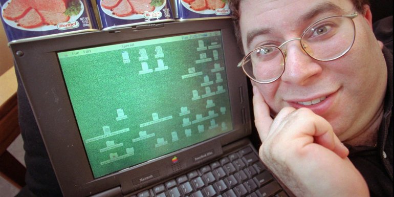 FILE - Sanford Wallace, president of Cyber Promotions, poses with his computer and cans of Spam processed meat in Dresher, Pa, in this May 8, 1997 file photo. Wallace, the self-proclaimed "Spam King," pleaded not guilty during an initial court appearance Thursday Aug. 4, 2011 after being indicted July 6 on six counts of electronic mail fraud, three counts of intentional damage to a protected computer and two counts of criminal contempt. The indictment filed in San Jose federal court said Wallace compromised about 500,000 Facebook accounts between November 2008 and March 2009 by sending massive amounts of spam through the company's servers on three separate occasions. (AP Photo/Dan Loh)